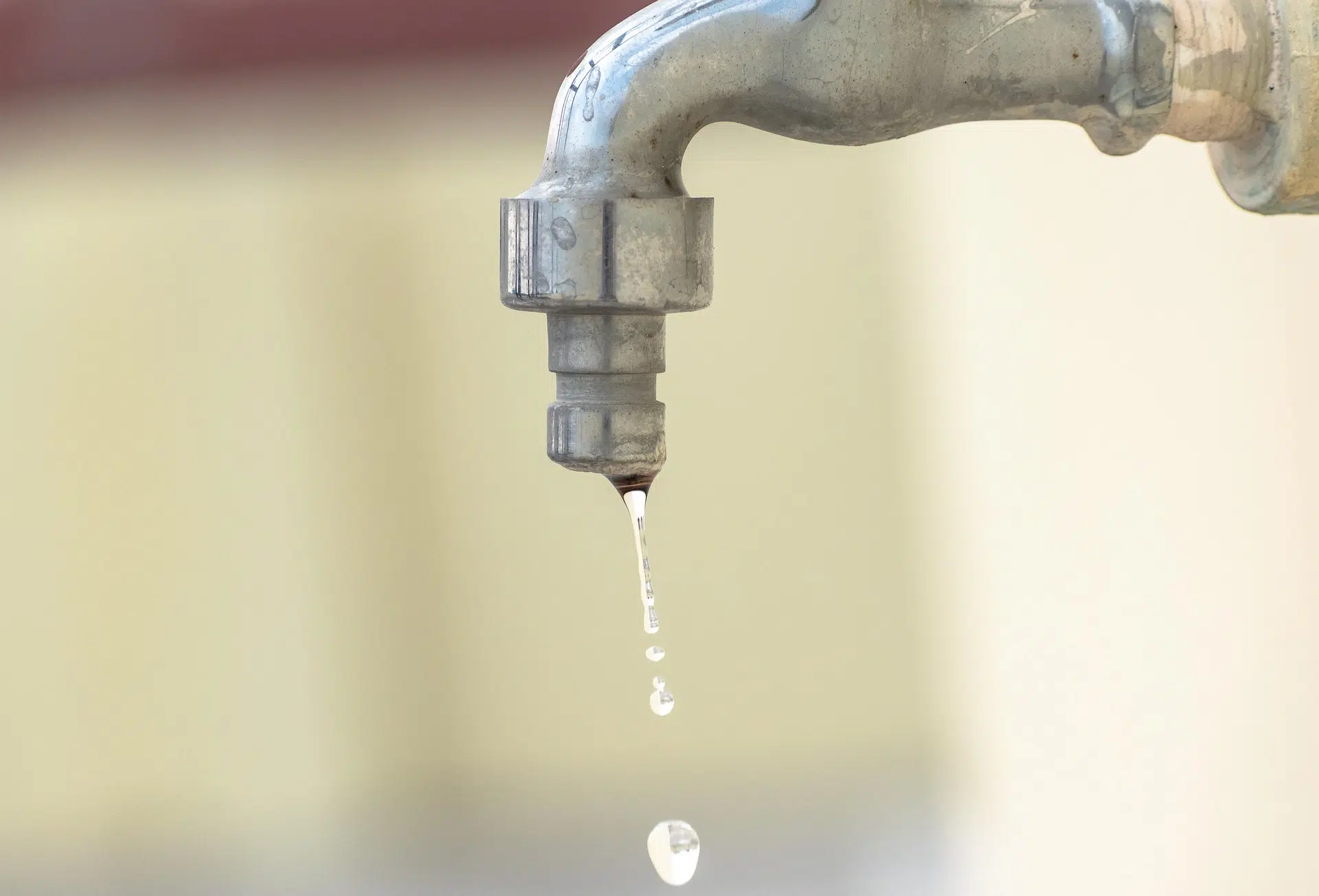 Dripping faucet illustrating the importance of repairing leaks to save water and promote sustainable water management at home.