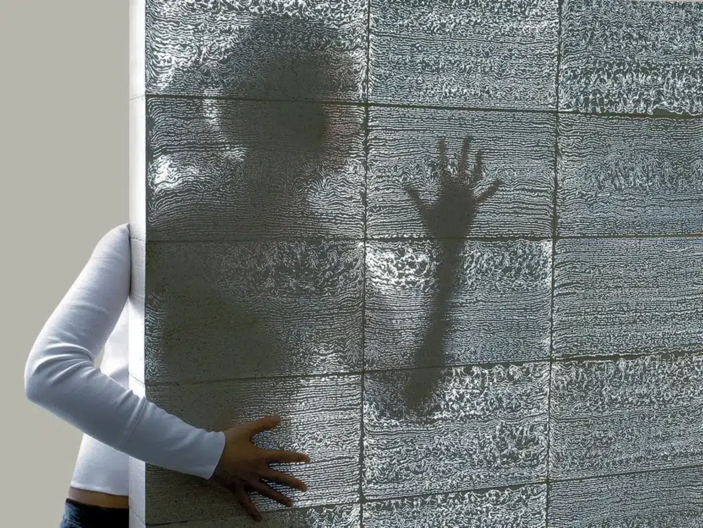Wall made of Litracon translucent concrete showing human silhouette — an example of new materials in residential architecture.