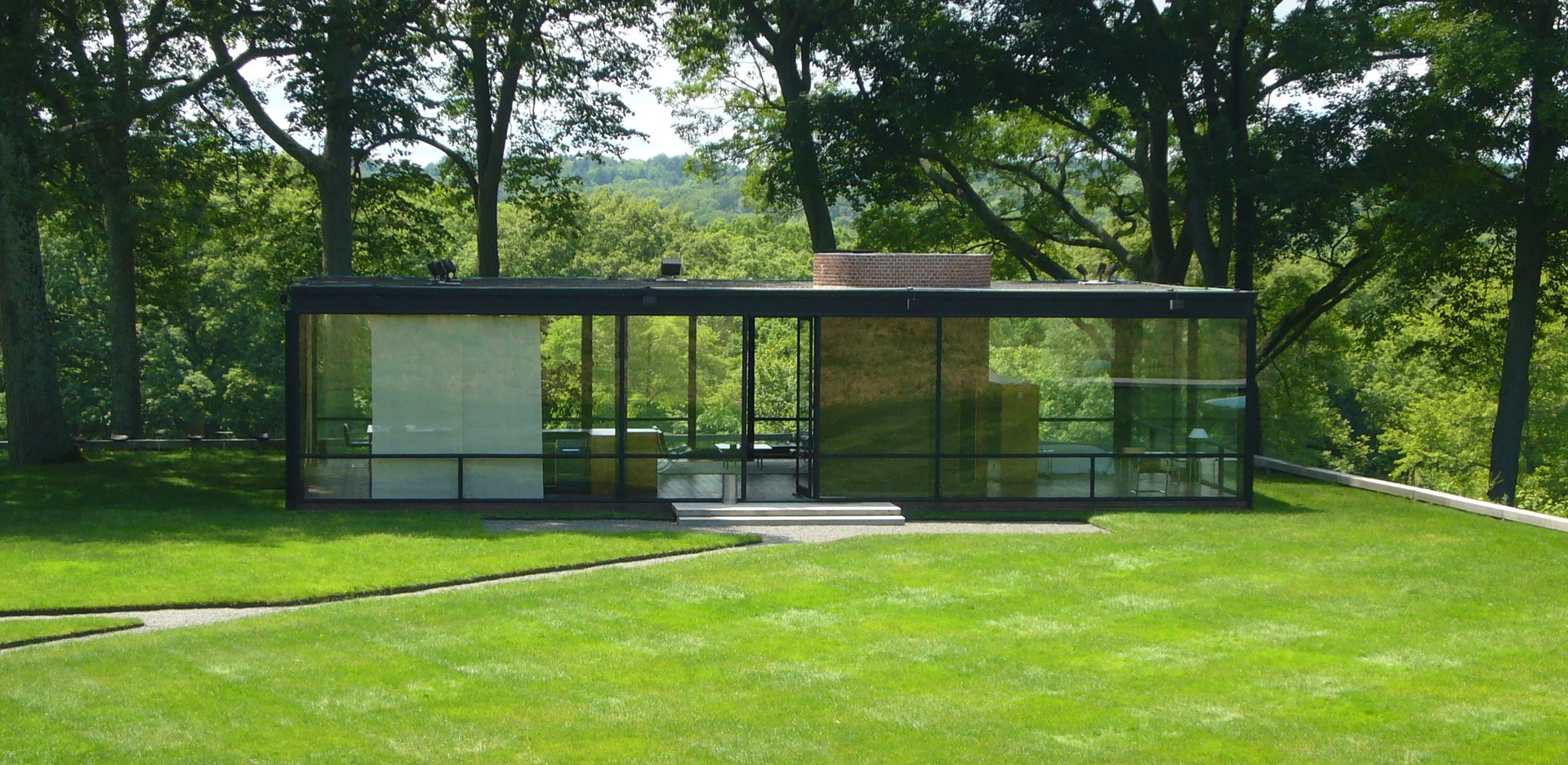 Philip Johnson’s Glass House in New Canaan, Connecticut — a landmark of architectural transparency and integration with the natural landscape.