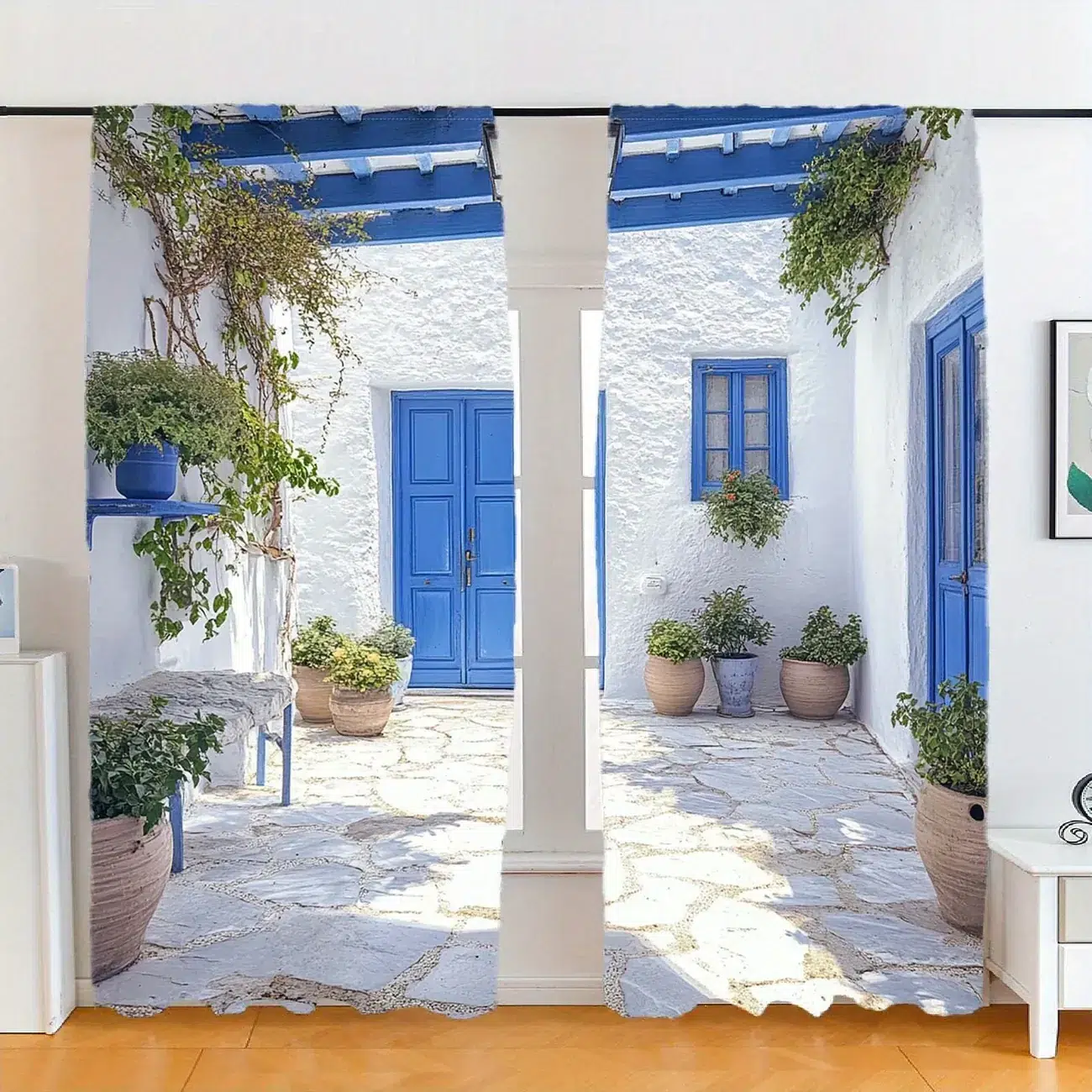 Whitewashed Mediterranean patio with blue wooden doors and windows, terracotta pots and climbing plants, reflecting traditional vernacular housing design.