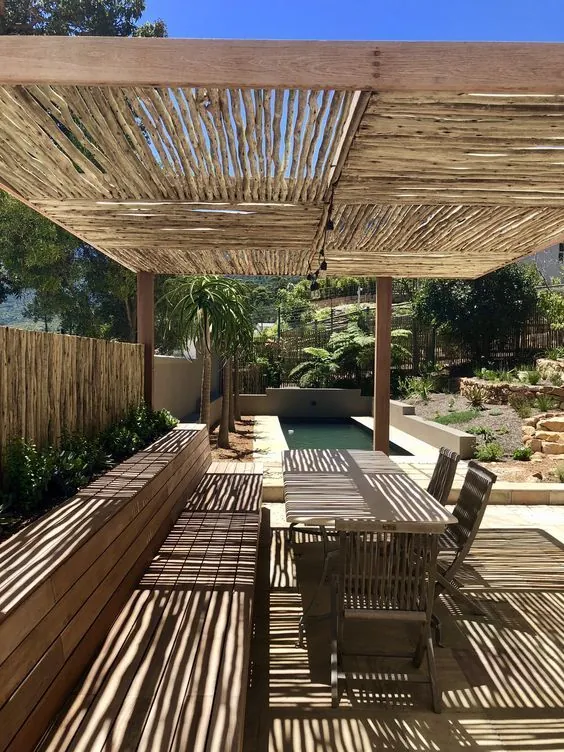 Bamboo pergola with linear shade in patio, dual seasonal design