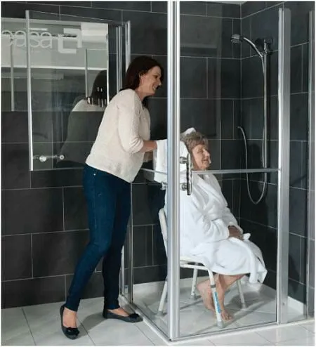 Glass enclosed shower with easy access in accessible housing