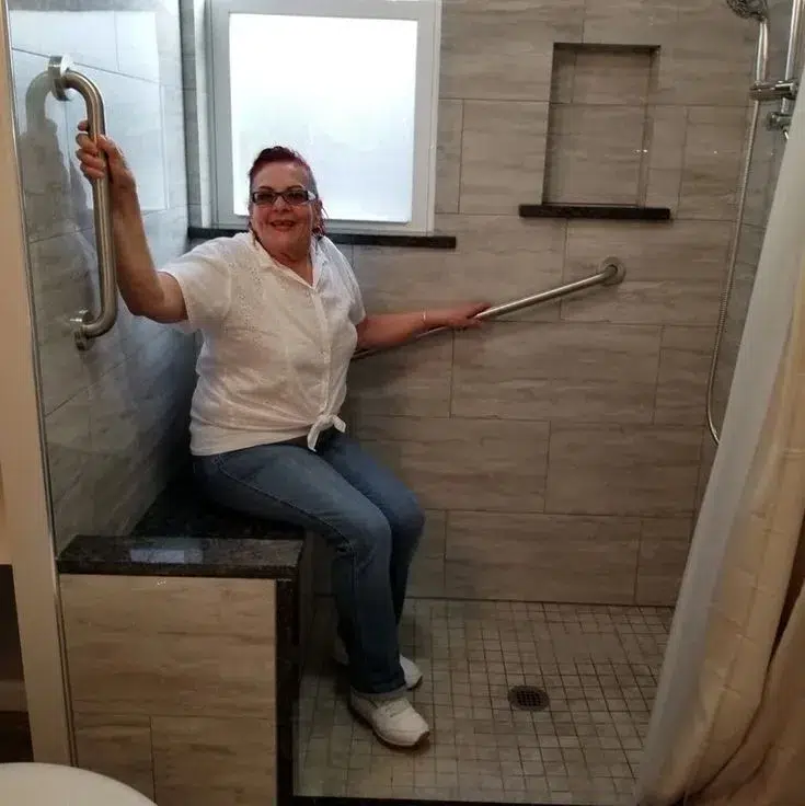 Shower with grab bars in accessible housing