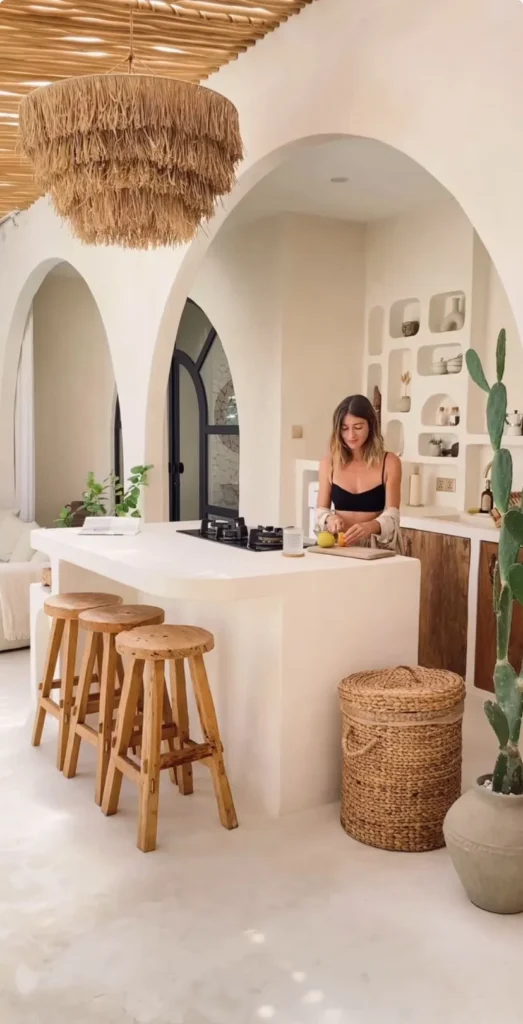 Minimal open-plan Spanish kitchen with natural-fibre pendants